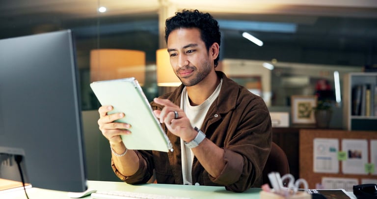 Digital marketing content creation with person working on laptop and tablet for campaigns