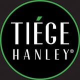 Tiege Hanley logo with white text and green circular border on dark background